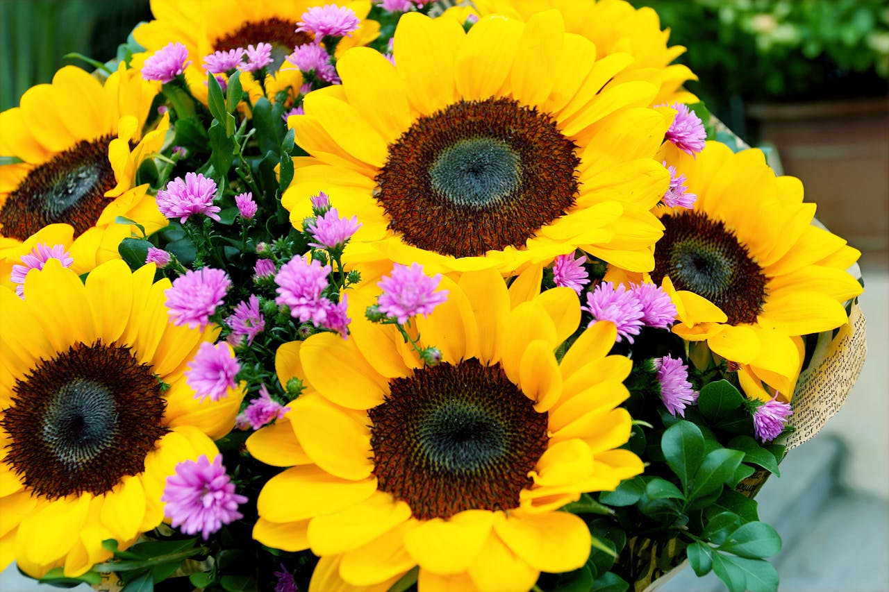 A stunning bouquet of sunflowers and purple flowers, perfect for brightening any space.